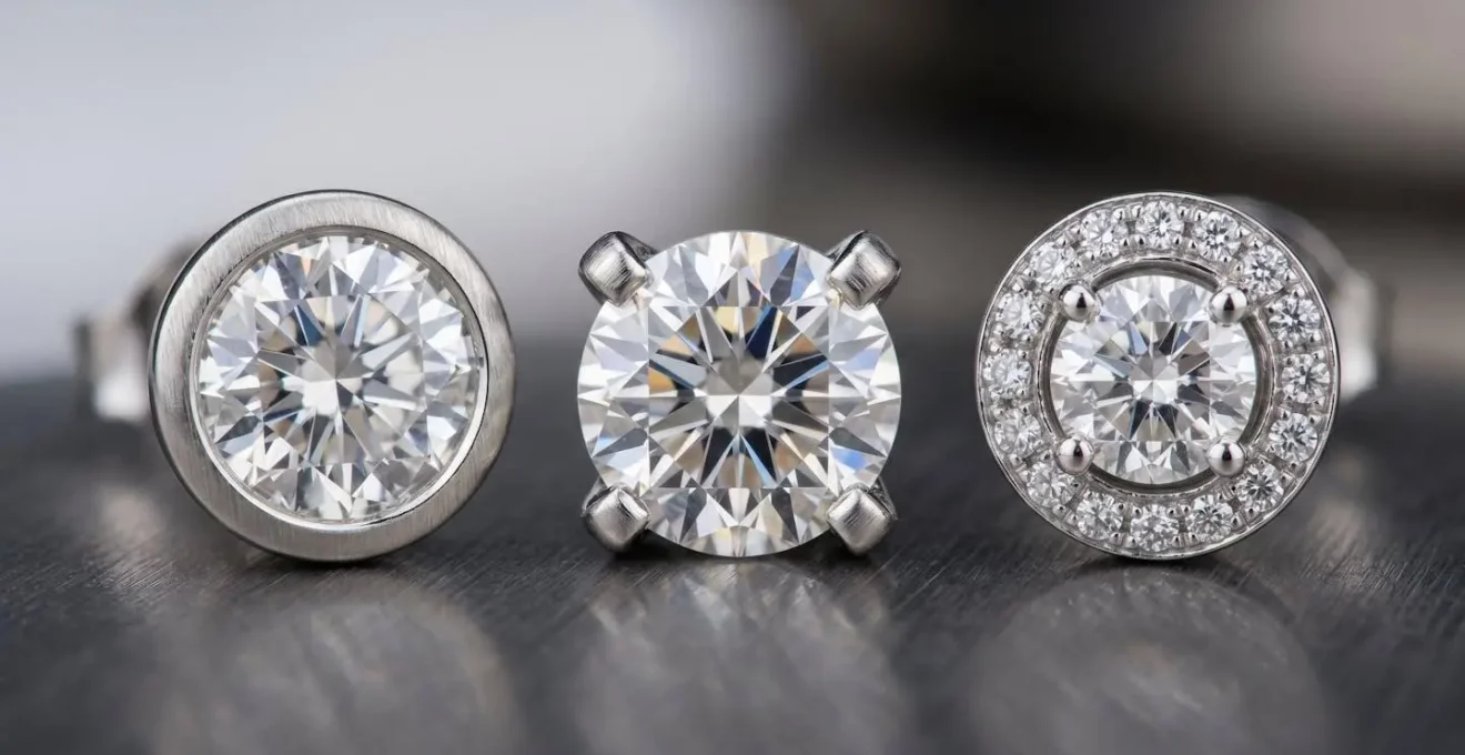 Makroaufnahme verschiedener Diamantfassungen im direkten Vergleich, die den Unterschied zwischen Krappen- und Zargenfassung zeigen.